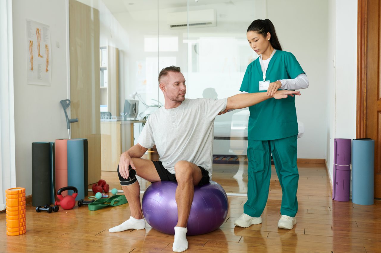 A patient working with a rehabilitation nurse.